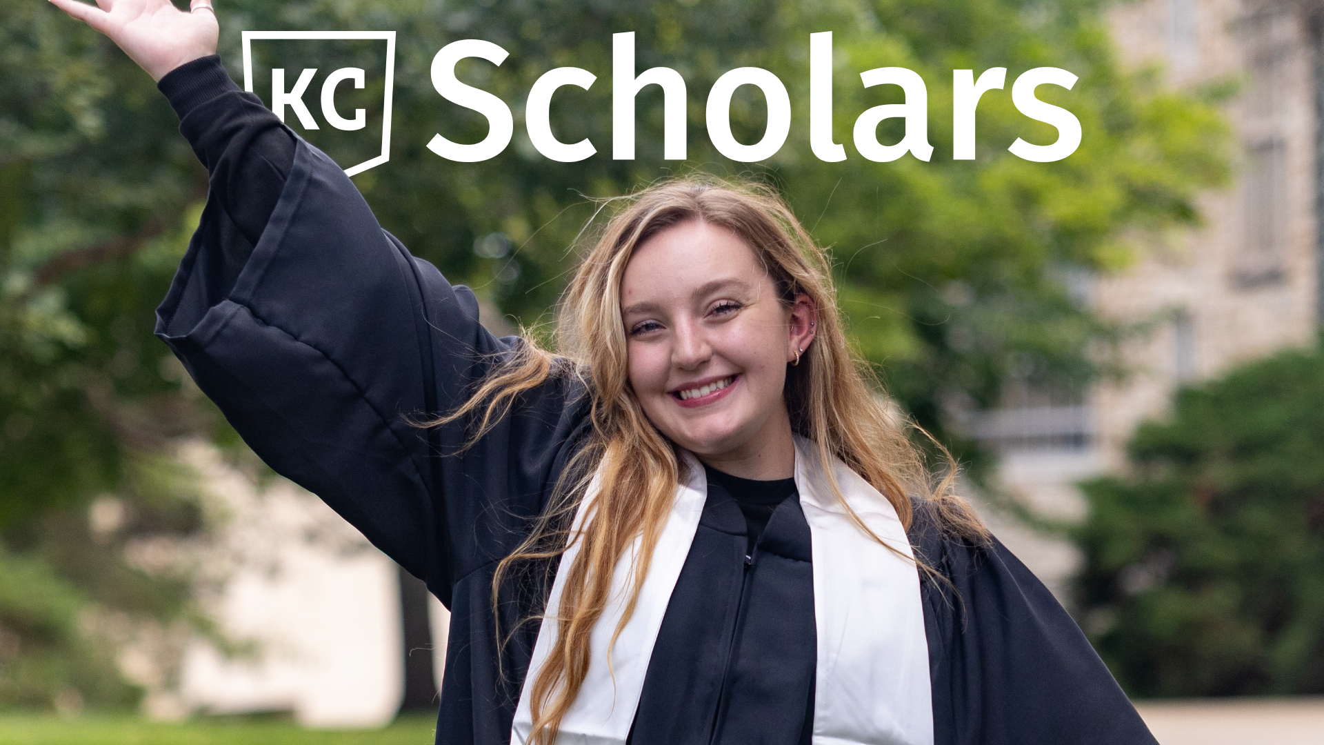 A person wearing a graduation gown smiles and raises one arm triumphantly, celebrating their new opportunities. The image features the "KC Scholars" logo, highlighting the scholarships that paved the way to their success.