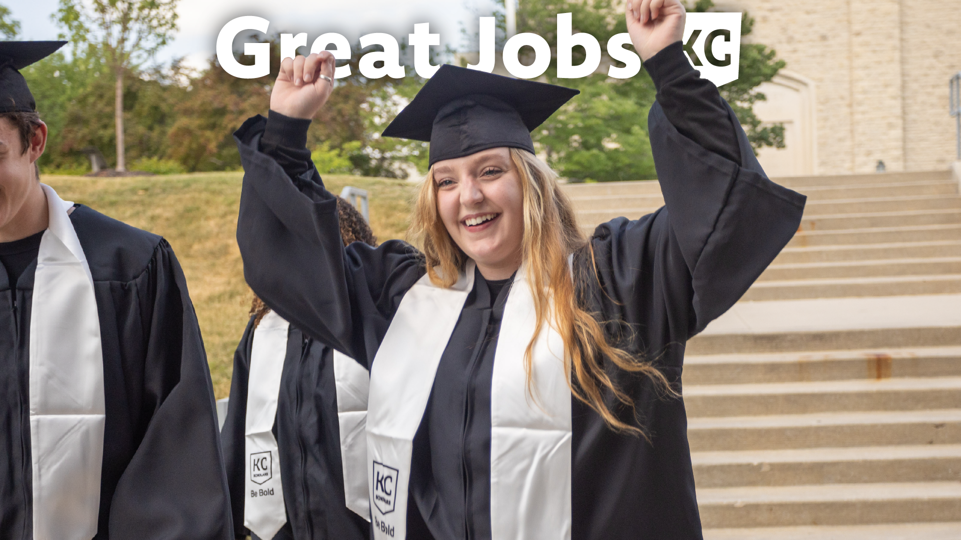 A graduate in a cap and gown raises their arms in celebration. The words "Great Jobs KC" are visible above, highlighting promising career opportunities for the future.