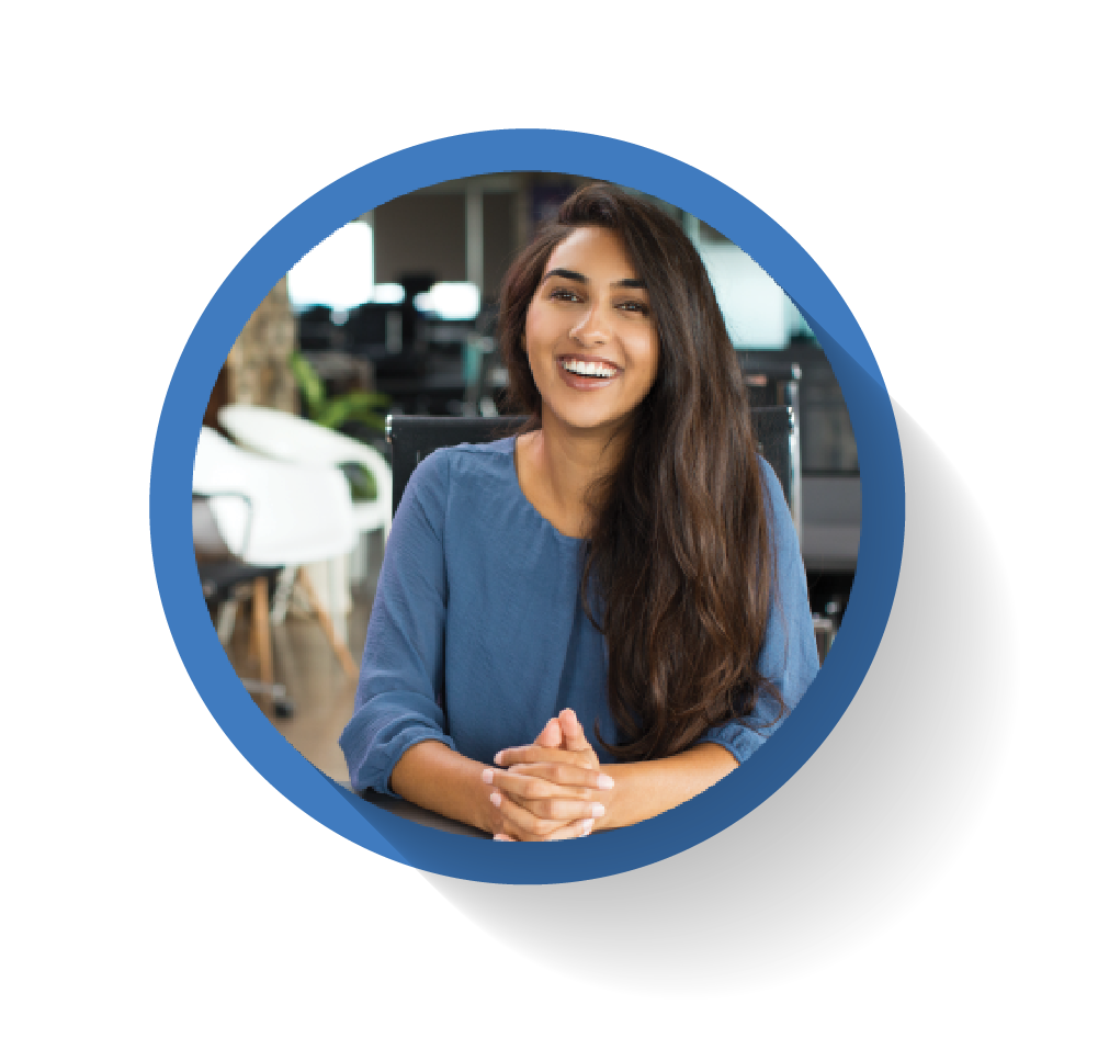 A woman with long hair sits at a desk, smiling confidently, seen within a blue circular frame, reflecting her successful career.