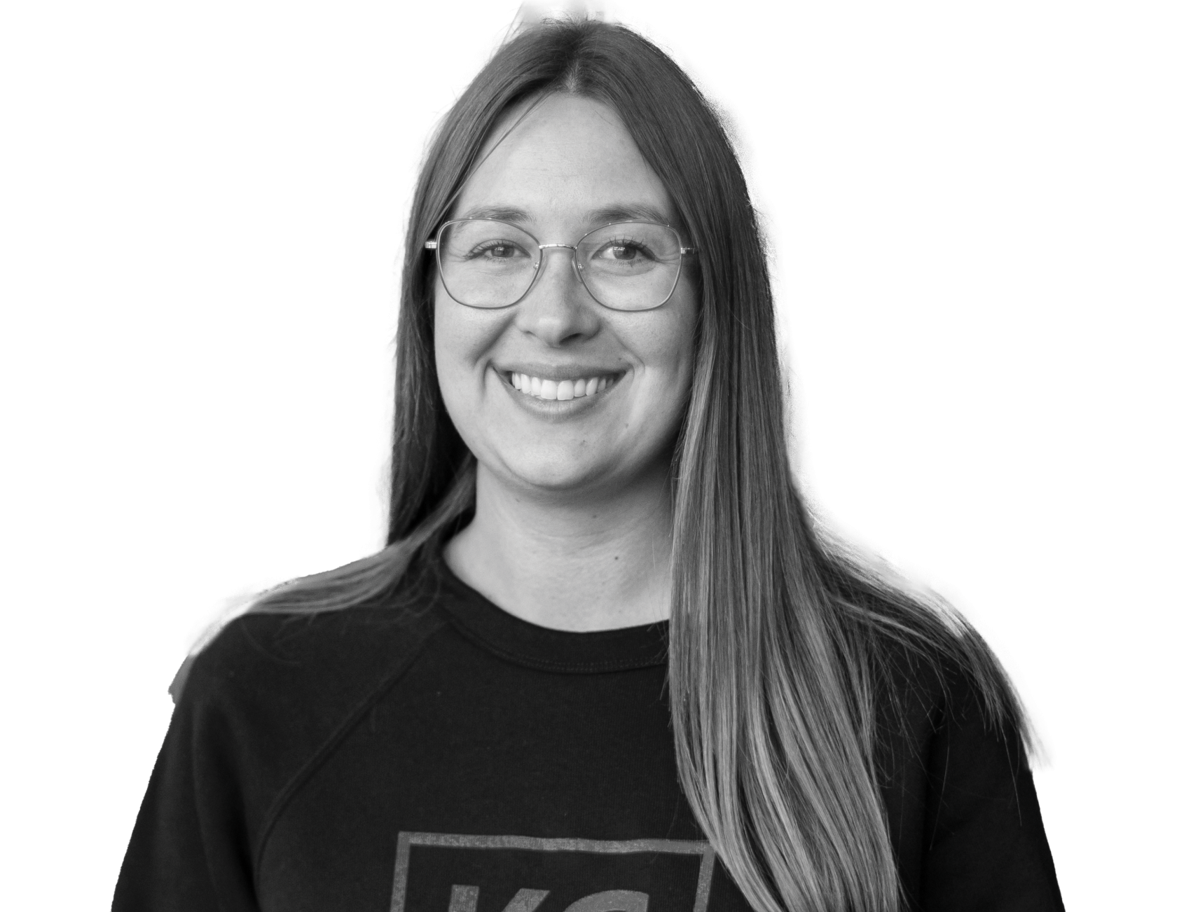 A woman wearing glasses and a KC Scholars sweatshirt holds a whiteboard with the handwritten words "Belonging + Purpose," embodying the themes highlighted in our annual report.