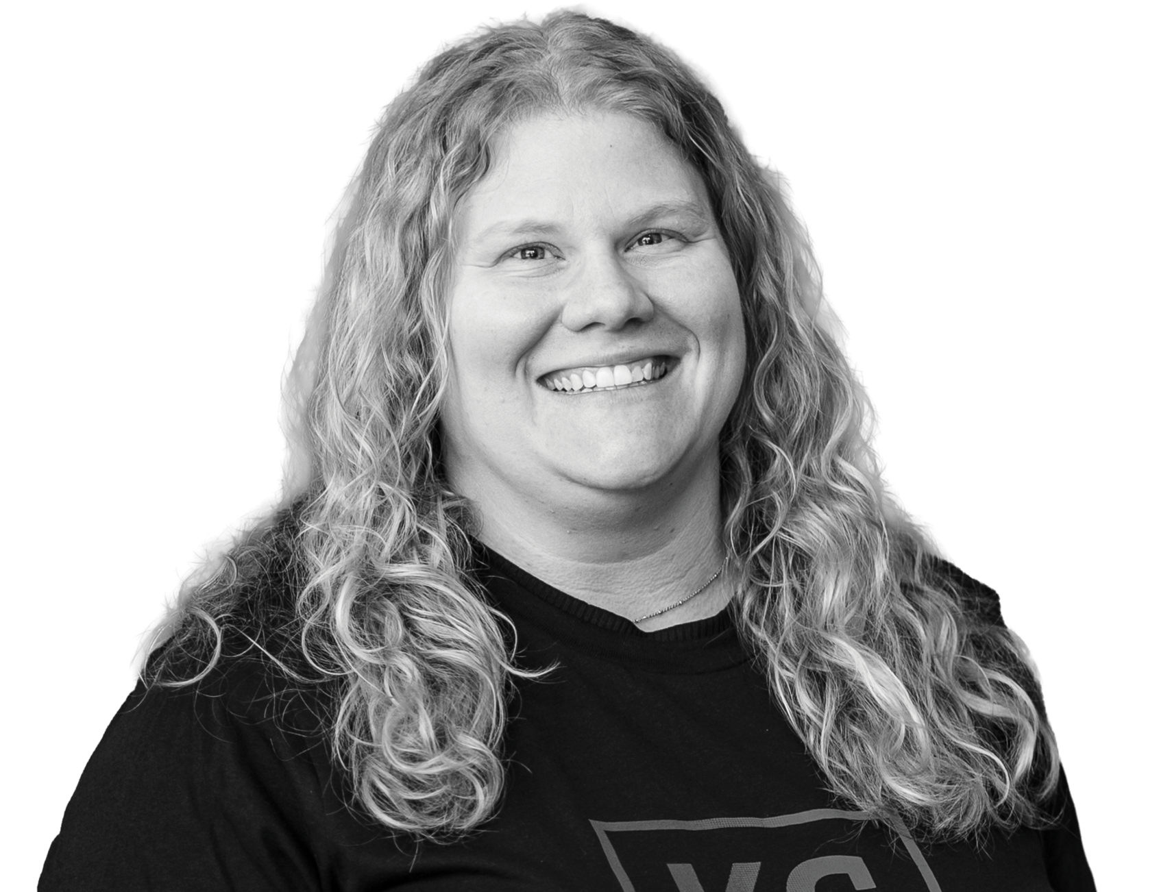 A person with long, curly hair smiles at the camera while wearing a dark "KC Scholars" t-shirt, proudly featured in the annual report.