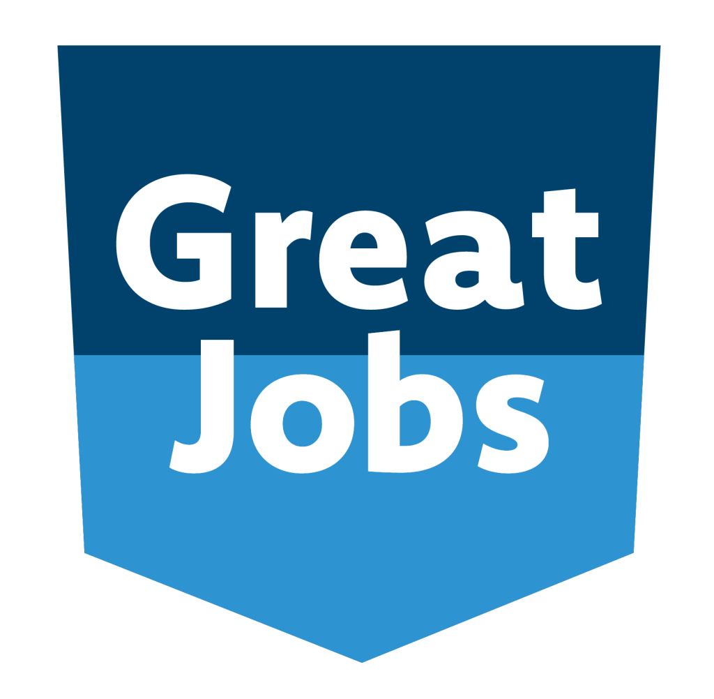 A blue shield-shaped badge for Ford County with the words "Great Jobs" in bold white letters, divided between a dark blue upper half and a lighter blue lower half.