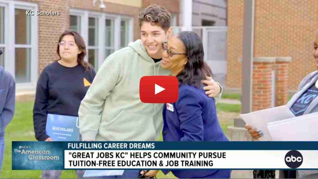 A young man smiles while being hugged by a woman in an outdoor setting, with others nearby holding folders. Text reads: “Great Jobs KC helps community pursue tuition-free education & job training.” Perfect for your press kit.